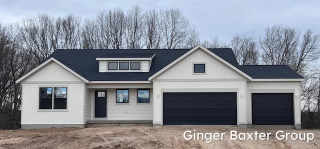 view of front of home featuring driveway, roof with shingles, and a garage