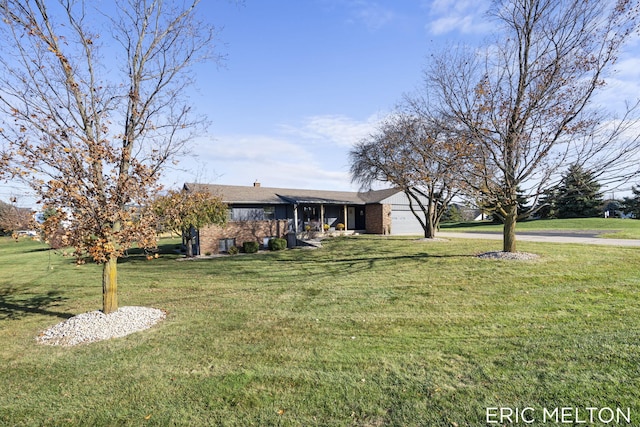 single story home featuring a garage and a front lawn