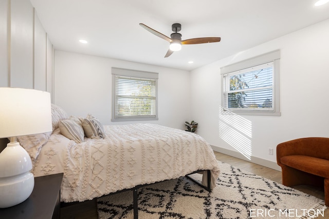 bedroom with light hardwood / wood-style flooring, multiple windows, and ceiling fan