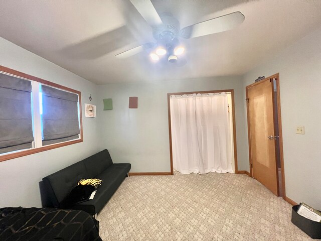 sitting room featuring ceiling fan and light colored carpet