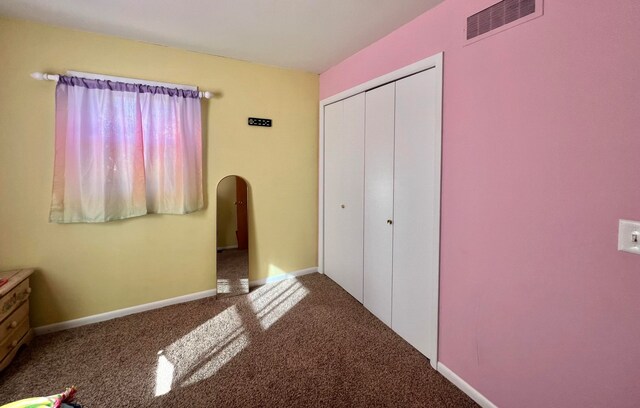 unfurnished bedroom with carpet flooring and a closet