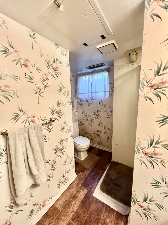 bathroom featuring hardwood / wood-style floors and toilet