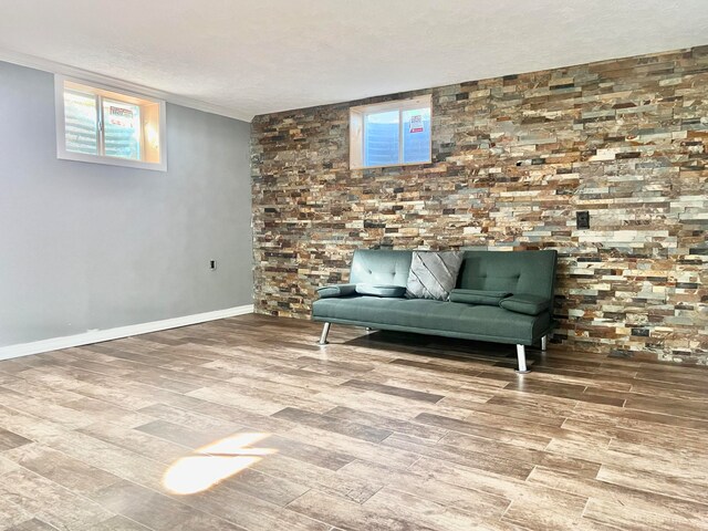 unfurnished room featuring hardwood / wood-style floors, a textured ceiling, and ornamental molding