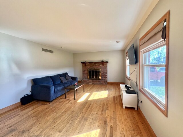 living room featuring a fireplace and light wood-type flooring