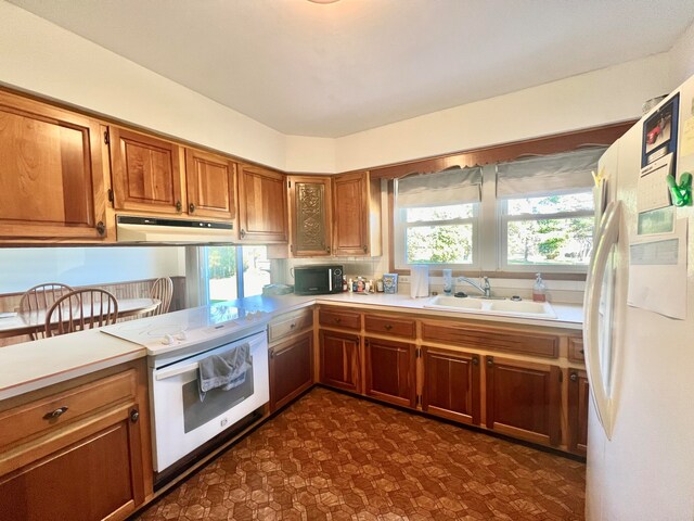 kitchen featuring sink and white appliances