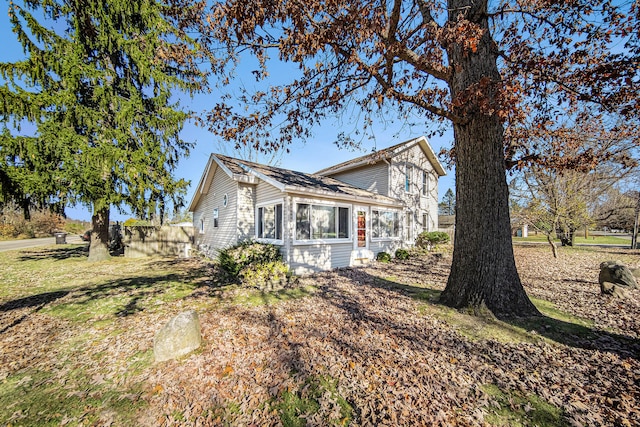 view of side of home featuring a yard