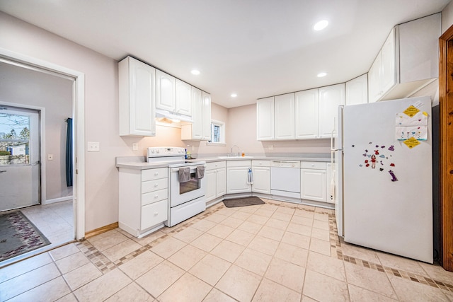 kitchen with white appliances, white cabinetry, sink, and light tile patterned flooring