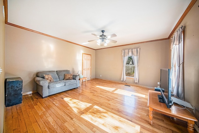 living room featuring light wood-type flooring, ceiling fan, and crown molding