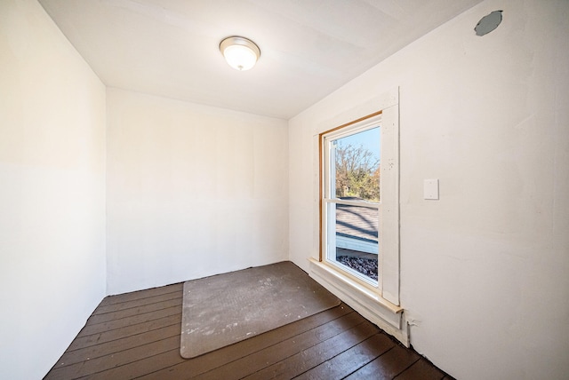 empty room with dark hardwood / wood-style flooring