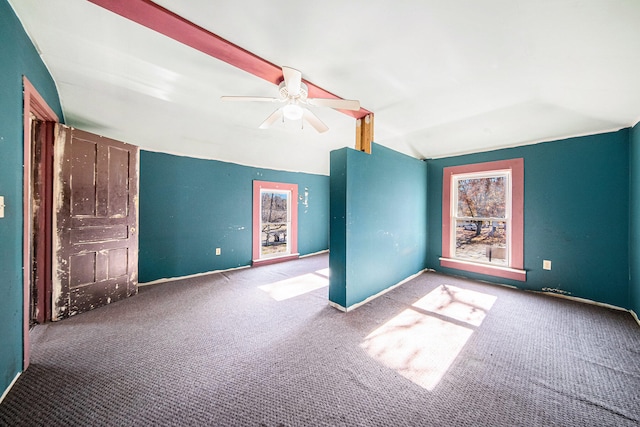 carpeted spare room with ceiling fan and lofted ceiling