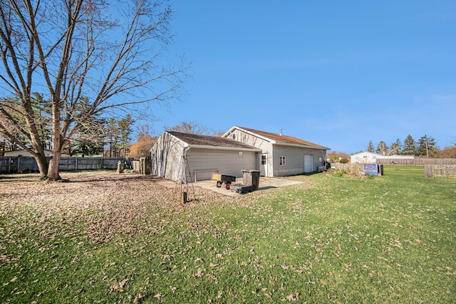 rear view of property with a patio area, a yard, and an outdoor fire pit