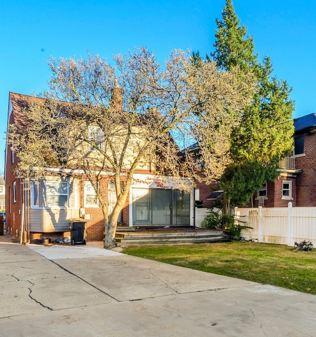 rear view of house with a yard