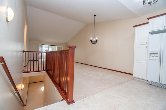 stairs with lofted ceiling, carpet floors, and an inviting chandelier