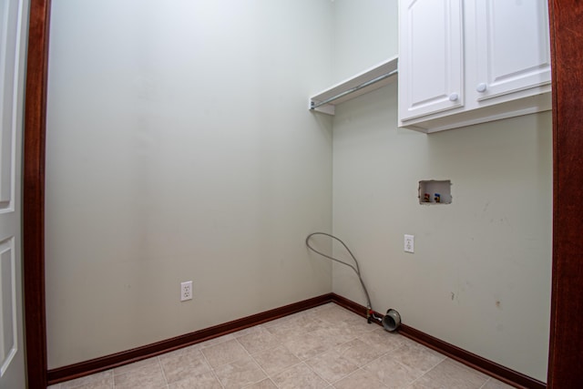 clothes washing area with hookup for a washing machine and cabinets