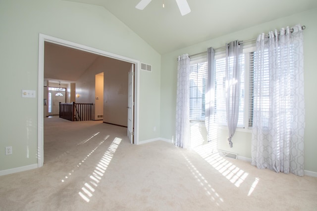 unfurnished room featuring vaulted ceiling, light colored carpet, and ceiling fan