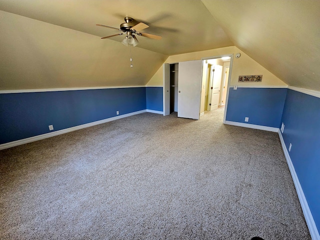 bonus room featuring lofted ceiling, carpet, and ceiling fan