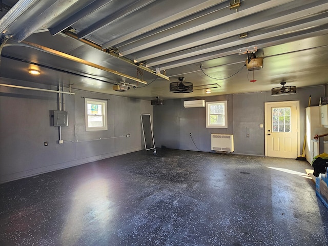 garage with a garage door opener, electric panel, a wall unit AC, and heating unit