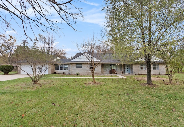 single story home featuring a garage and a front lawn