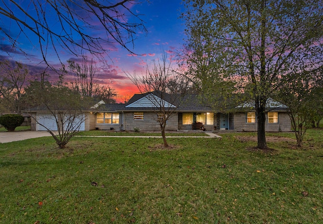 ranch-style home with a lawn and a garage