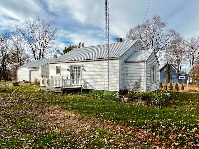 rear view of property featuring a yard and a deck