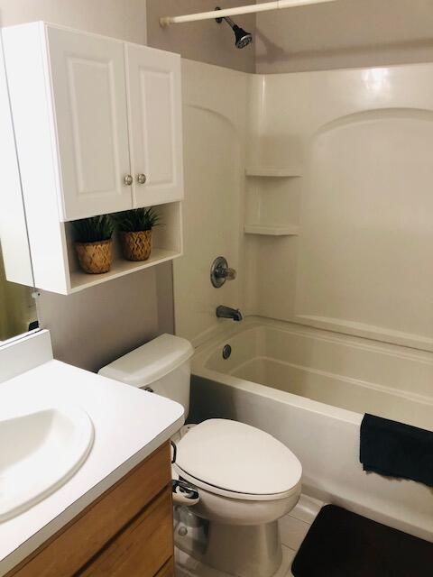 full bathroom with toilet, bathing tub / shower combination, vanity, and tile patterned flooring