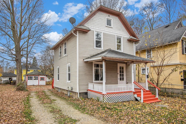 view of front of home featuring an outbuilding and a porch