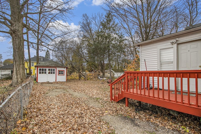 view of yard featuring an outdoor structure and a wooden deck