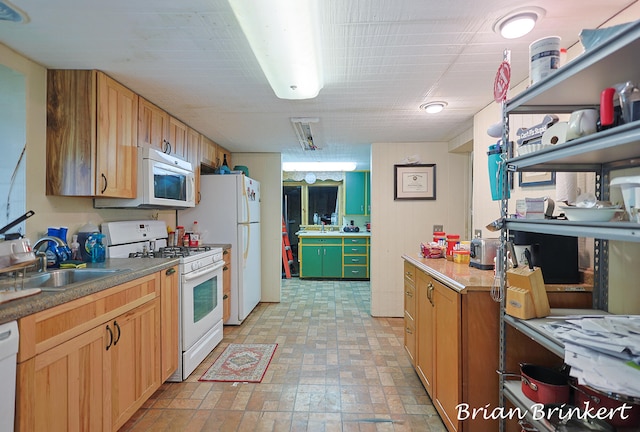 kitchen with sink and white appliances