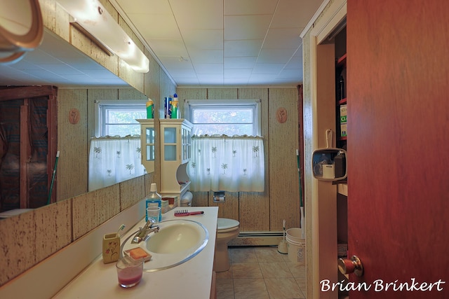 bathroom with vanity, tile patterned flooring, toilet, and a baseboard radiator