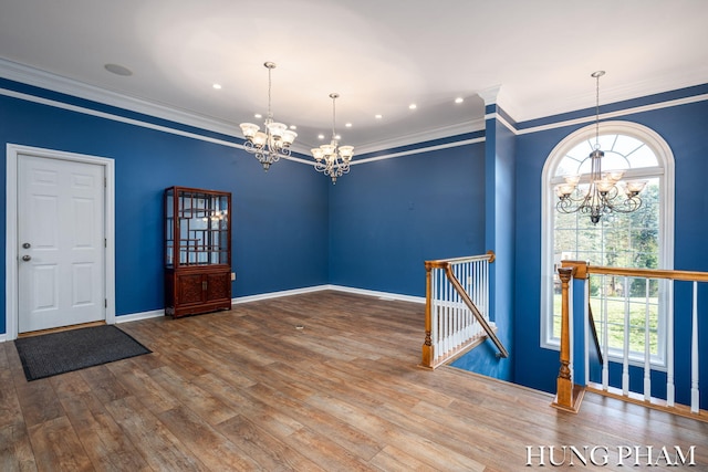 entryway featuring a wealth of natural light, wood-type flooring, and crown molding