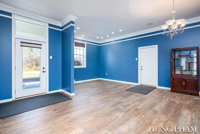 entrance foyer with a wealth of natural light, hardwood / wood-style floors, and ornamental molding