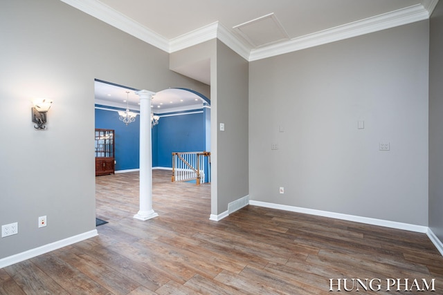 empty room featuring wood-type flooring and ornamental molding