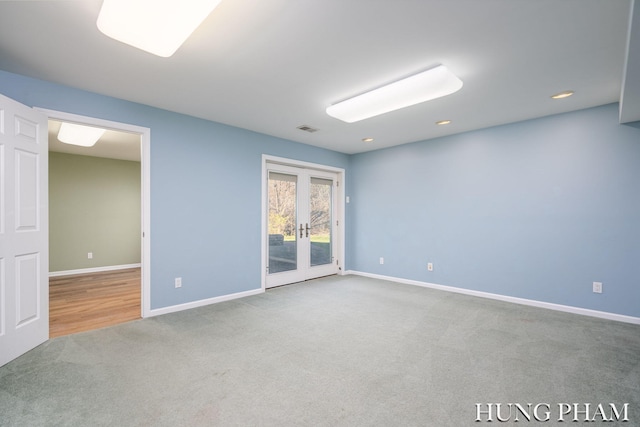 empty room featuring carpet flooring and french doors