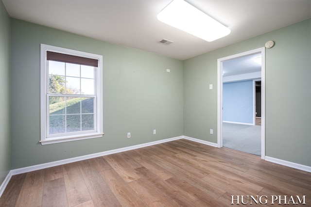 spare room with light hardwood / wood-style floors