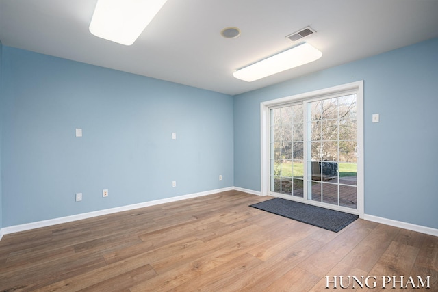 spare room with hardwood / wood-style flooring