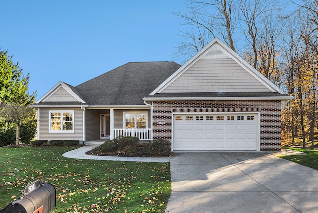 view of front of home featuring a porch, a front yard, and a garage