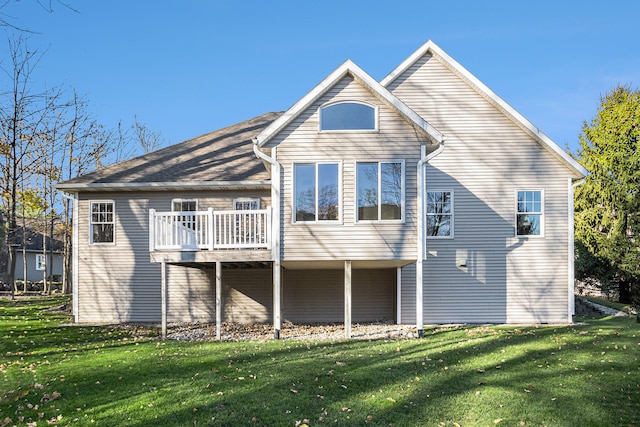 rear view of property with a yard and a wooden deck