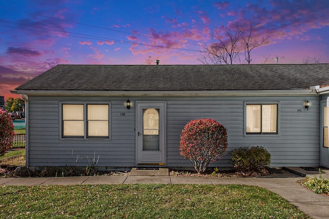 ranch-style home with a lawn