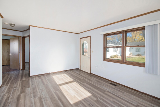 spare room featuring ornamental molding and wood-type flooring