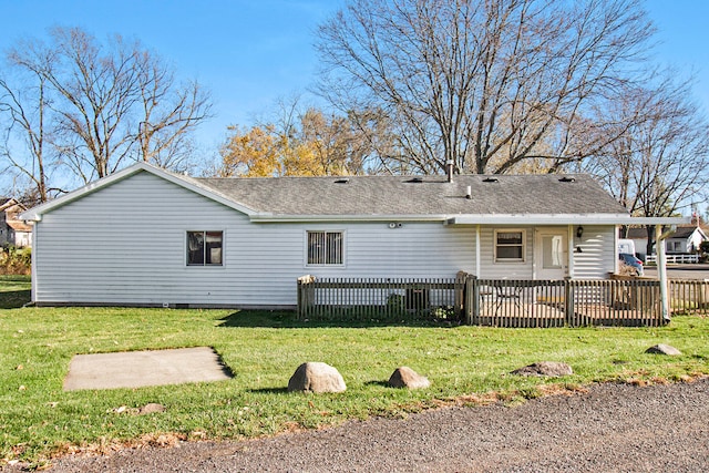 back of property featuring a yard