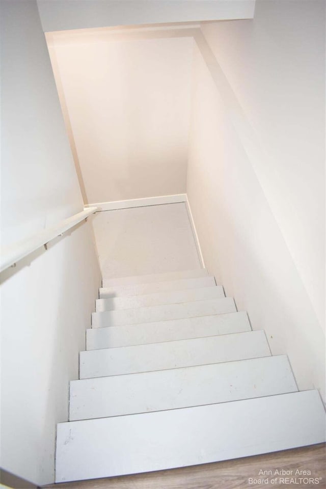 stairway with wood-type flooring