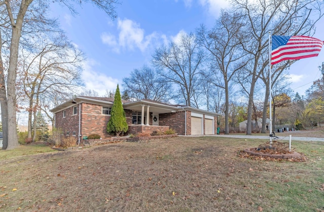 view of side of property with a garage, covered porch, and a yard