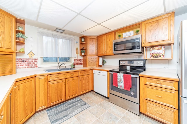 kitchen featuring stainless steel appliances, a paneled ceiling, and sink