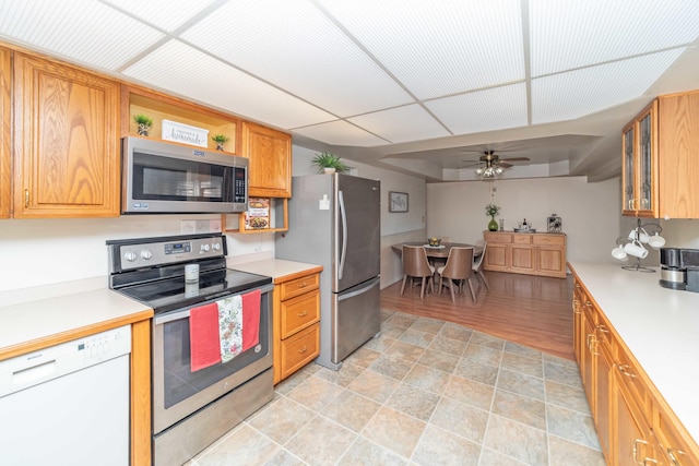 kitchen featuring a paneled ceiling, appliances with stainless steel finishes, ceiling fan, and light hardwood / wood-style flooring