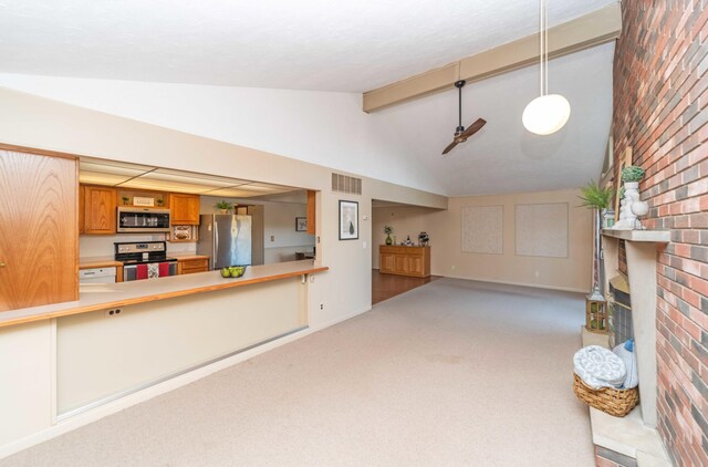 unfurnished living room with lofted ceiling with beams, light carpet, and a fireplace