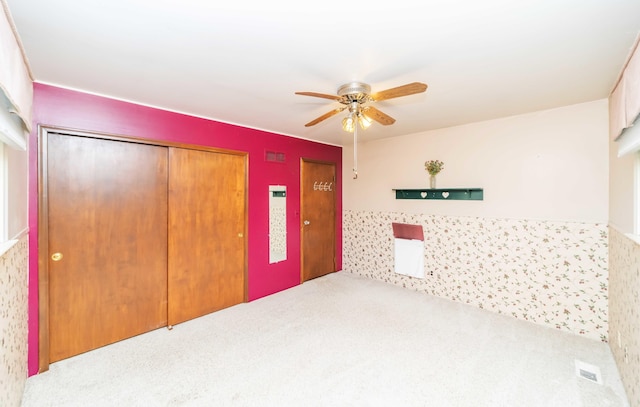 carpeted empty room with ceiling fan