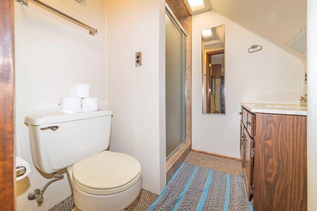 bathroom with toilet, vanity, an enclosed shower, and tile patterned floors