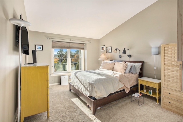 bedroom featuring light carpet and vaulted ceiling