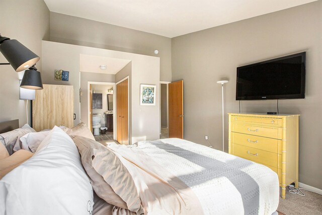 bedroom featuring carpet and connected bathroom