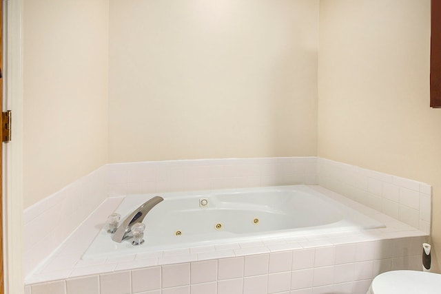 bathroom with toilet and a relaxing tiled tub